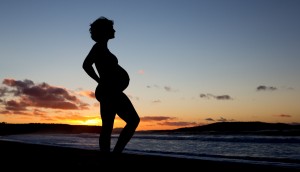 pregnant woman at sunrise